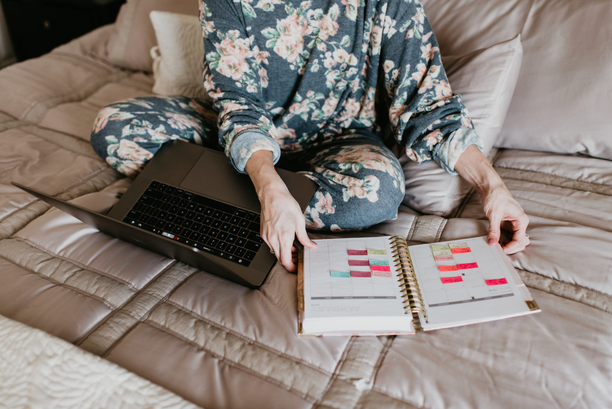 5 Planner Organization Tips for a Successful Year by popular Las Vegas lifestyle blogger Outfits & Outings: image of a woman working on her laptop and looking at her Day Designer planners with Happy Planner stickers