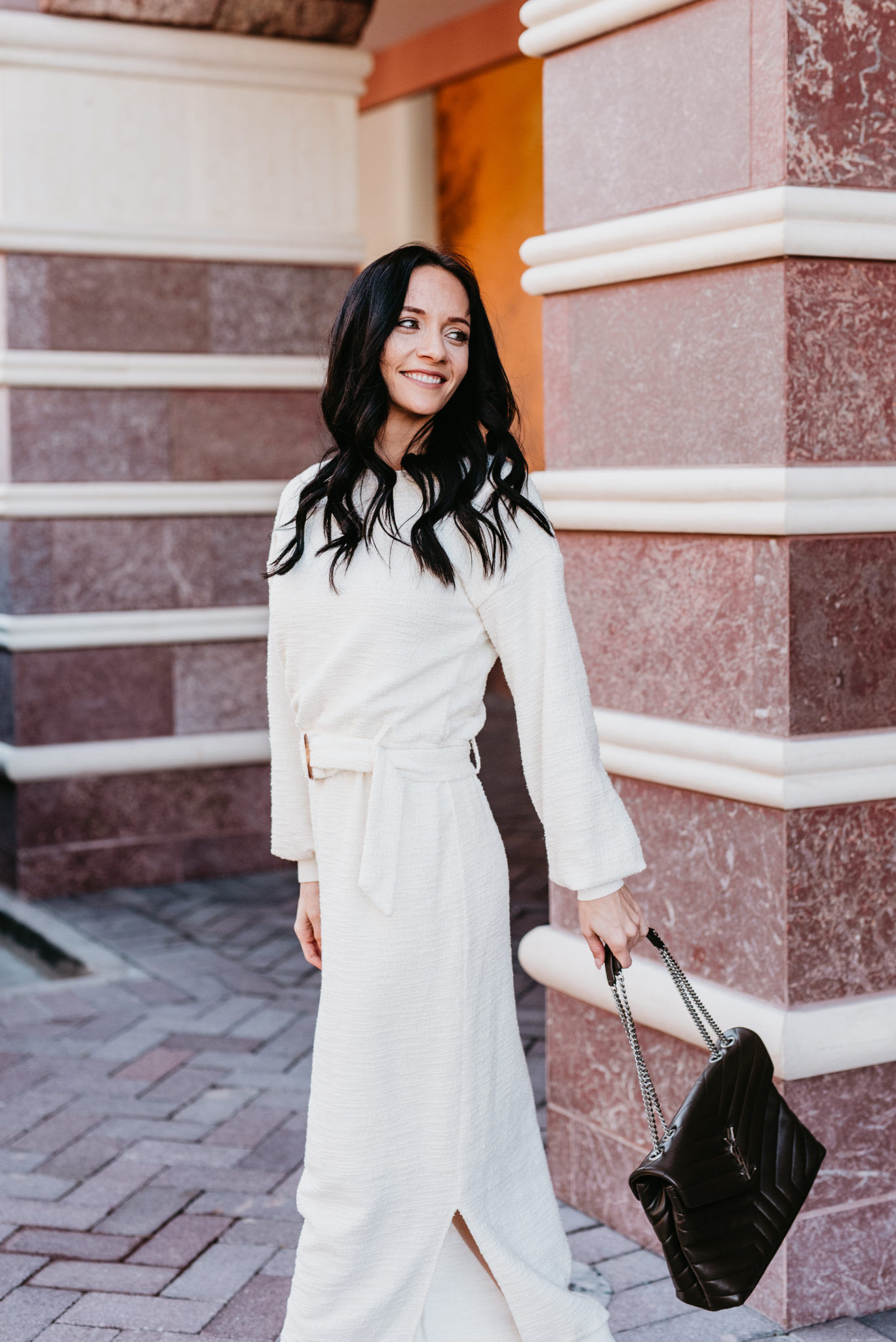 Cute Spring dress look styled by top US fashion blog, Outfits & Outings: image of a woman wearing a white Anthropologie belted dress, Yves Saint Laurent shoulder bag, and Marc Fisher white booties