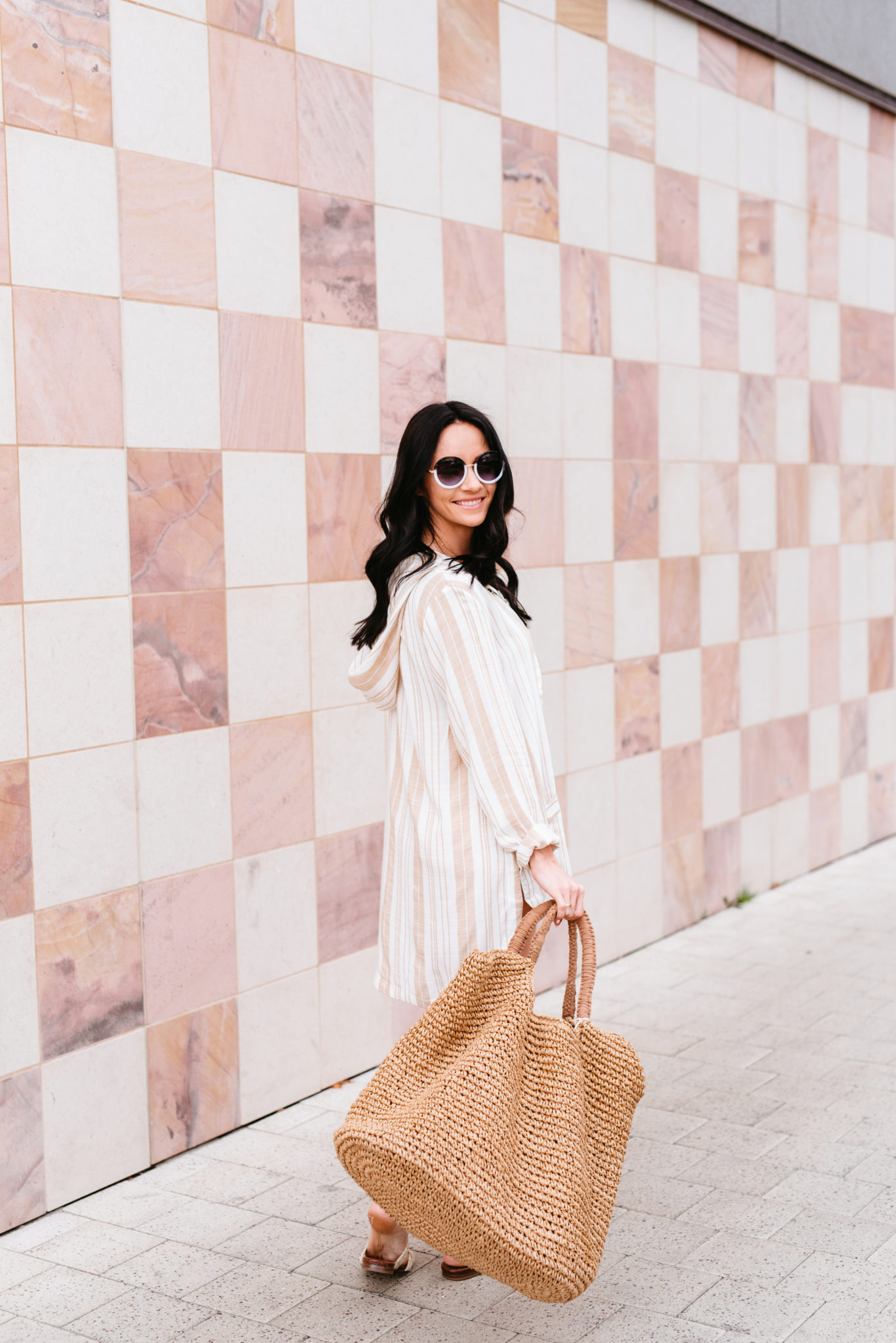 Top 15 Cute Swimsuit Coverups for Spring & Summer featured by top US fashion blog, Outfits & Outings: image of a woman wearing an L Space striped swimsuit coverup, mules, Nordstrom raffia tote and BP round sunglasses