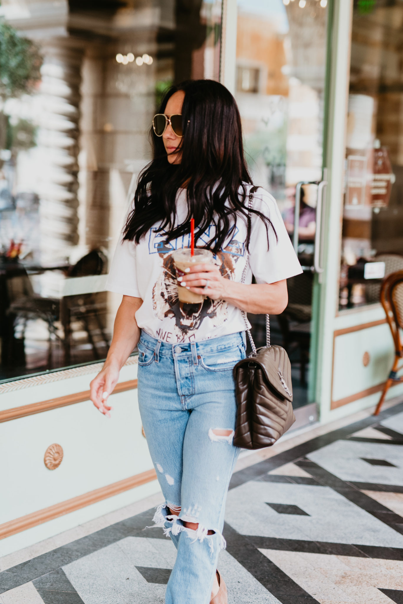 How to Wear a Graphic Tee this Fall, styling tips featured by top US fashion blog, Outfits & Outings: image of a woman wearing an Anime Bing tiger graphic tee, Levi’s wedgie jeans, Free People flats, Saint Laurent shoulder bag, Jimmy Choo aviator sunglasses