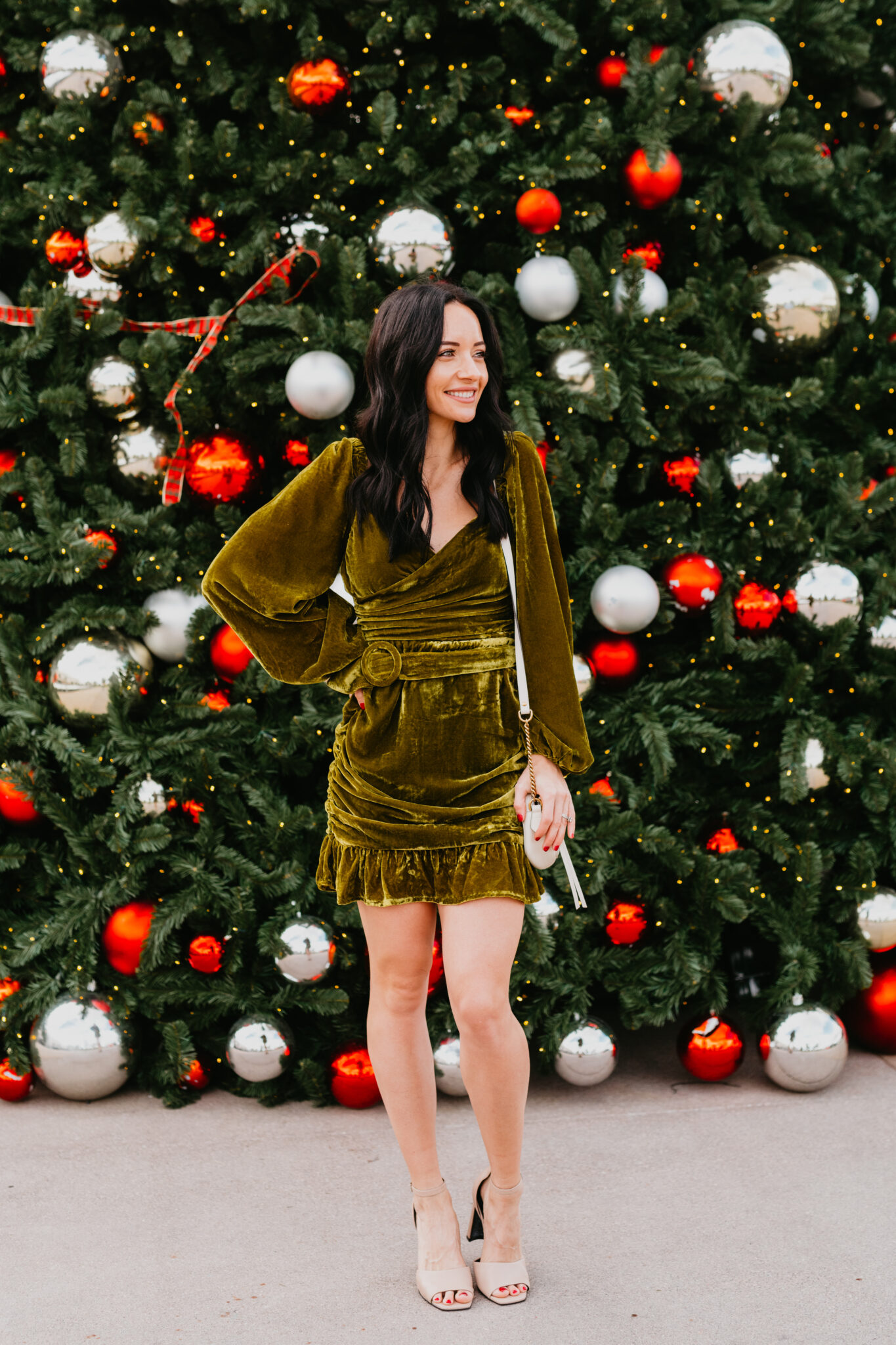 Festive Christmas Outfit Ideas featured by top US fashion blog, Outfits & Outings: image of a woman wearing a Tularosa velvet mini dress