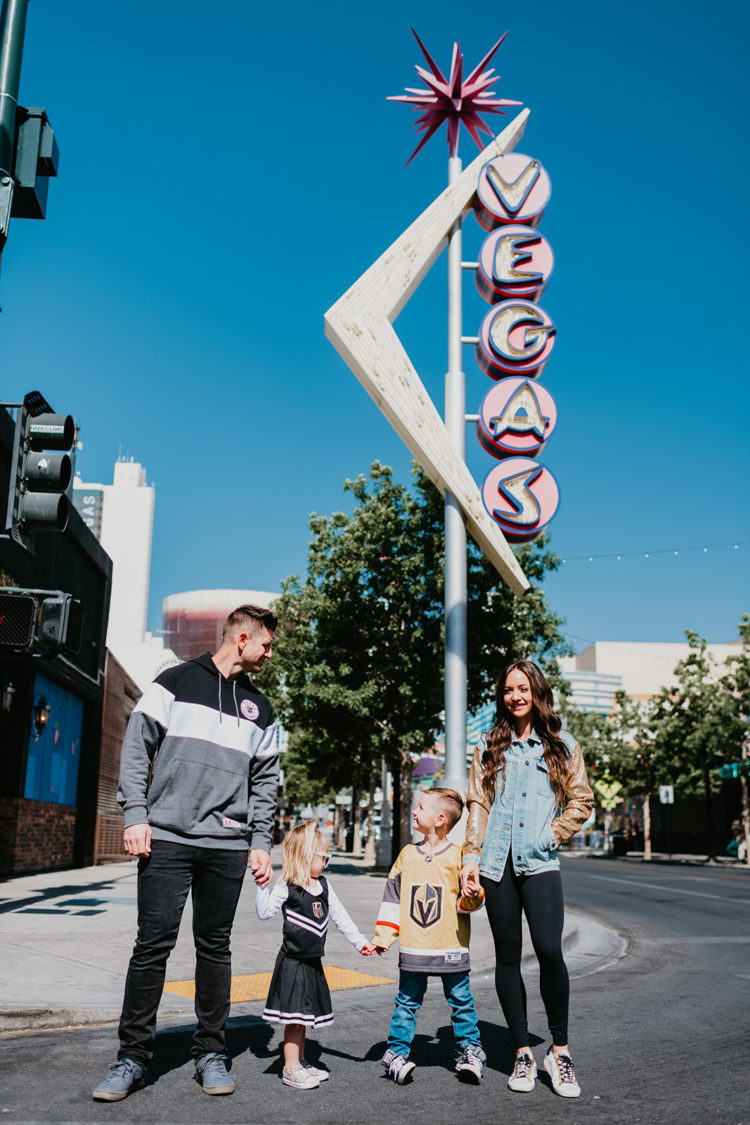 Golden Knights Gear by popular Las Vegas fashion blog, Outfits and Outings: image of a family standing in front of a old Vega sign and wearing Golden Knights gear. 
