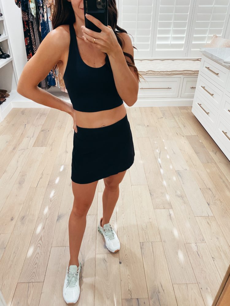 Nordstrom Anniversary Sale 2021 by popular Las Vegas fashion blog, Outfits and Outings: image of a pair of white sneakers, black sports bra and black athletic sneakers. 