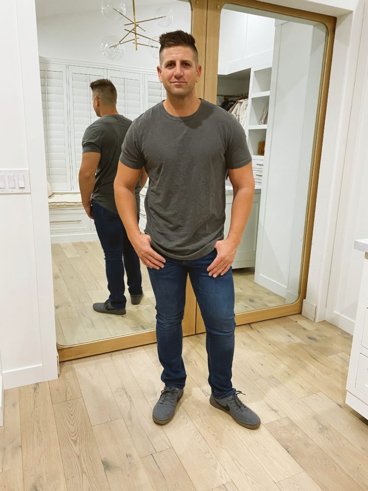 Nordstrom Anniversary Sale 2021 by popular Las Vegas fashion blog, Outfits and Outings: image of a man wearing a grey t-shirt, jeans, and grey nike sneakers. 
