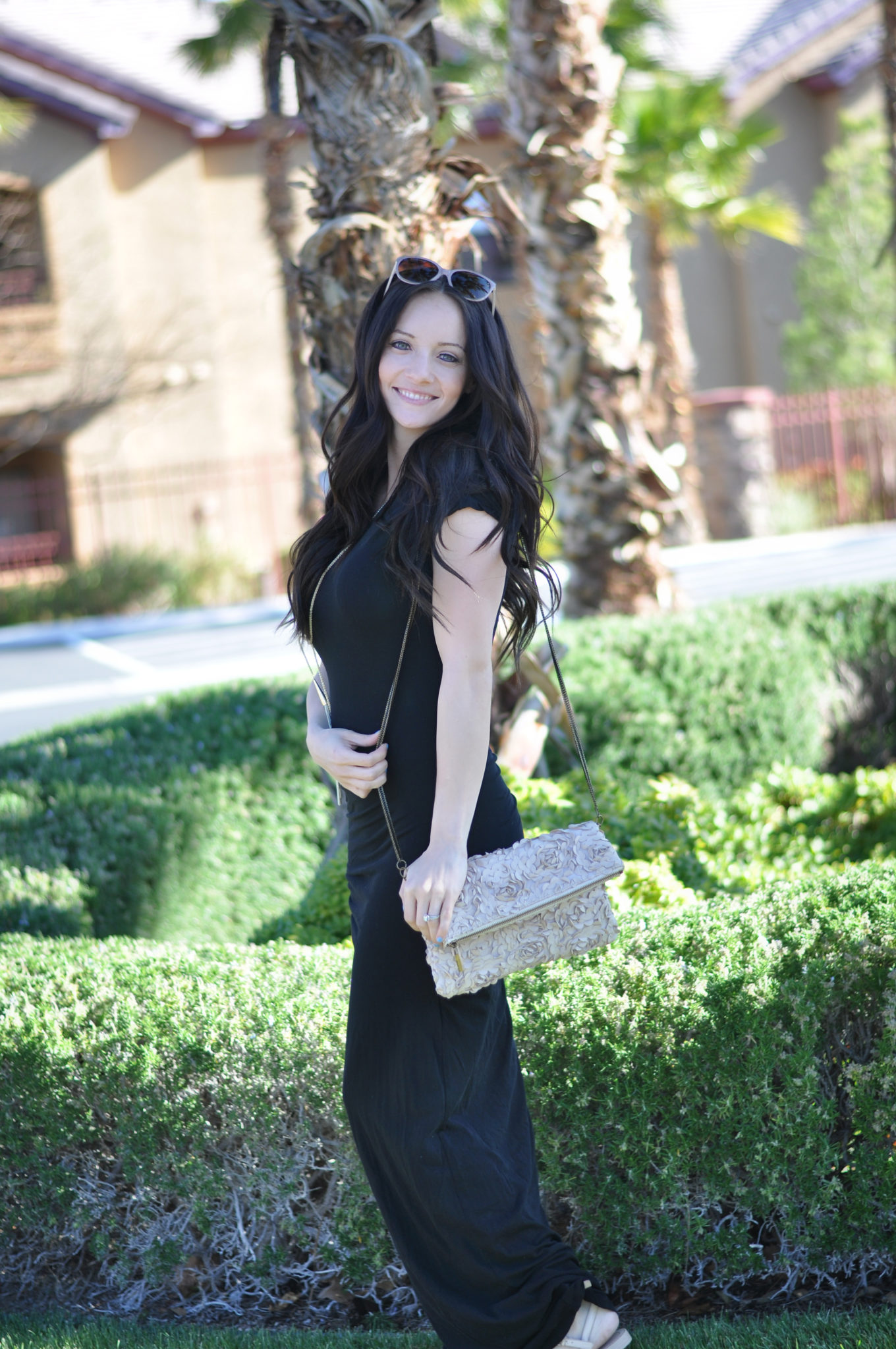 Cute Spring Outfits featured by top US fashion blog Outfits & Outings; Image of a woman wearing black dress.