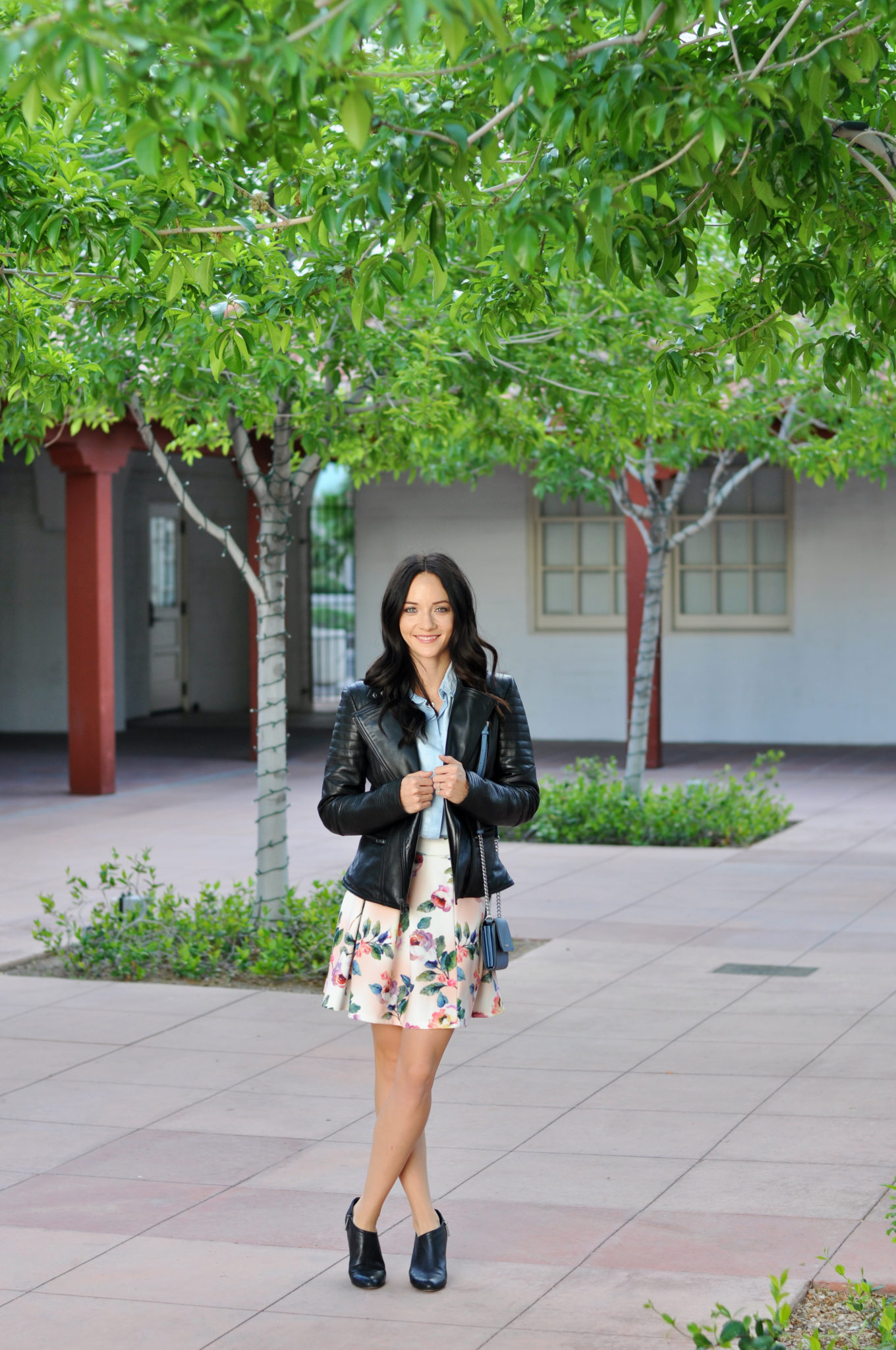 Spring Leather Jacket featured by top US fashion blog Outfits & Outings; Image of a woman wearing Wilsons Leather jacket and floral skirt.