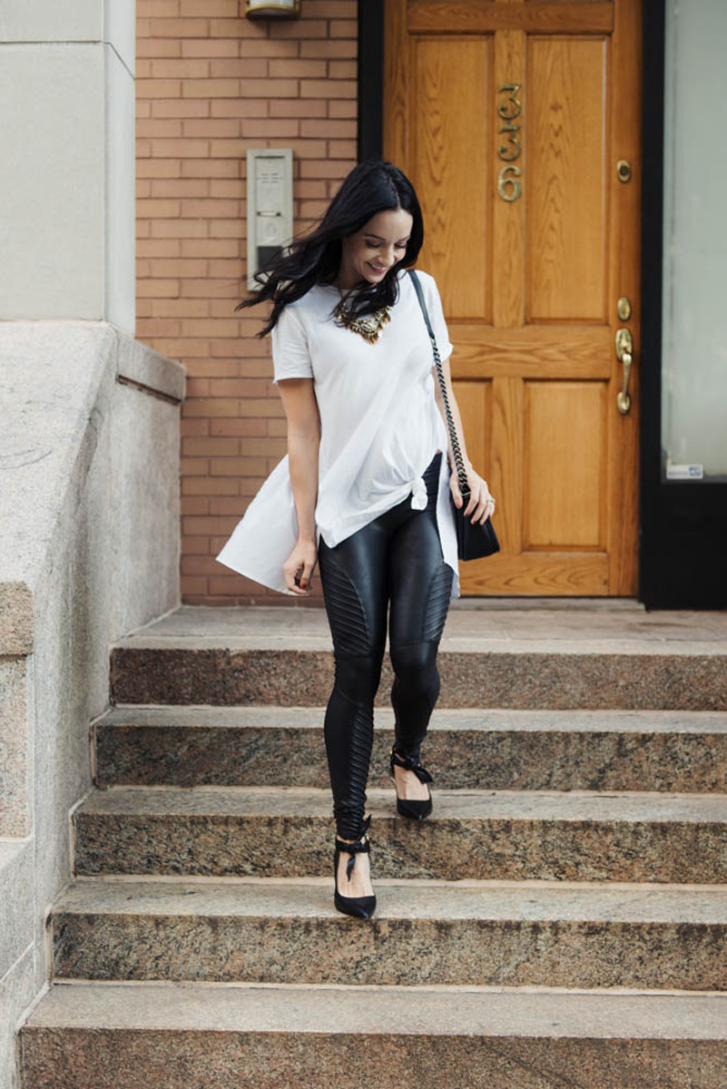 faux leather leggings outfit with long white top, Spanx Moto leggings, and black pumps
