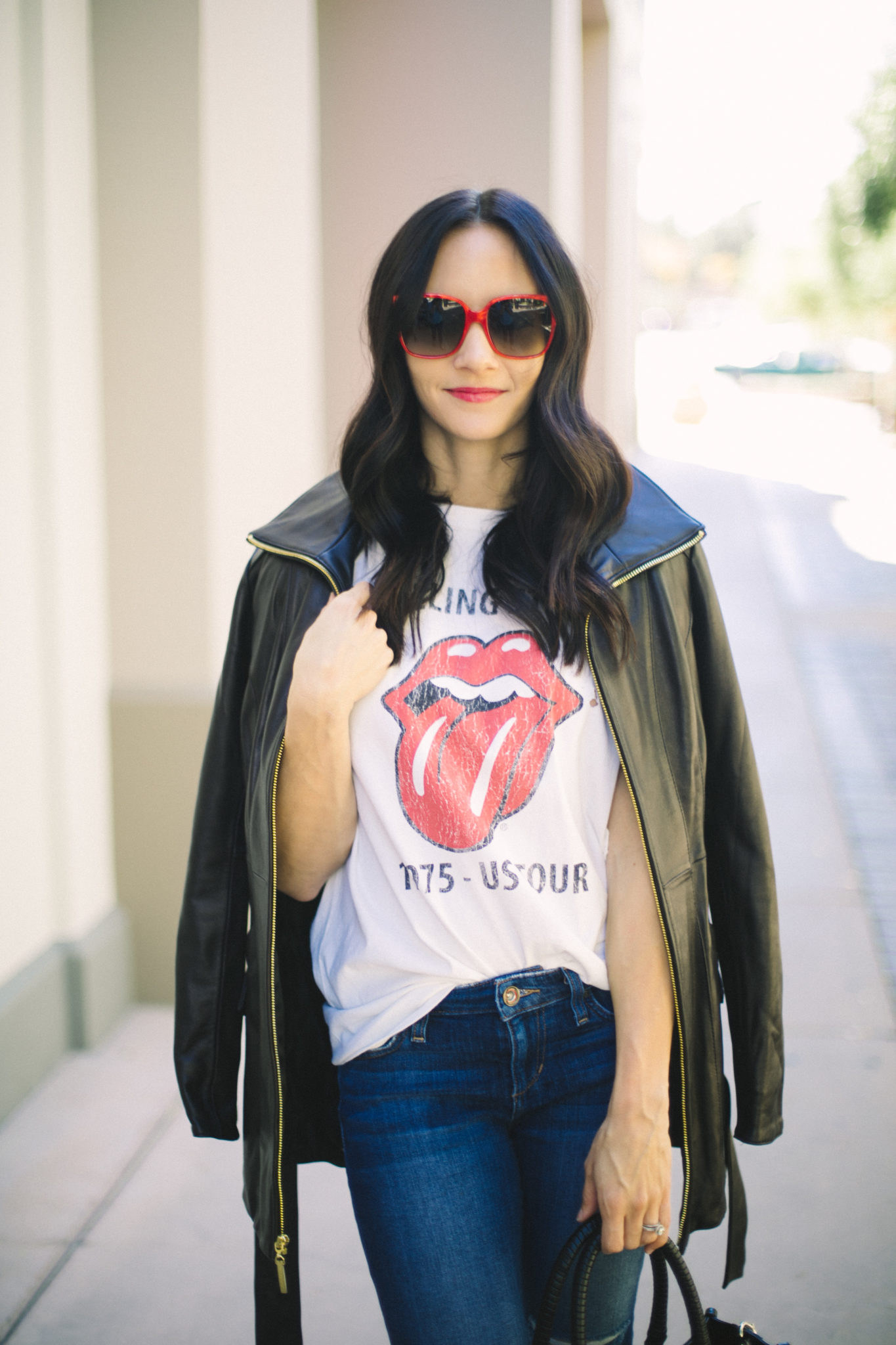 vintage band tee with caped leather jacket and red sunglasses fall outfit