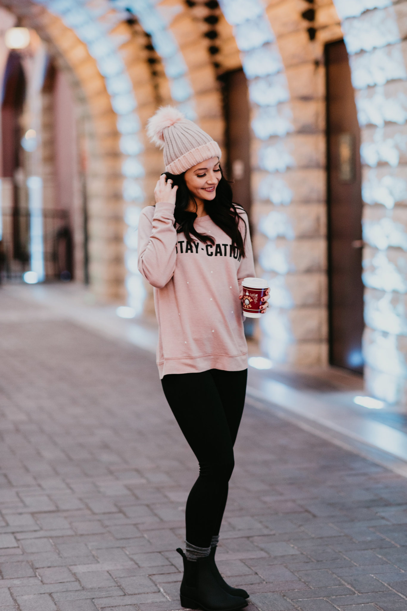 cozy winter outfit rain booties black leggings pink sweatshirt and pink beanie plus a list of 15 ways to treat yourself - 15 Ways to Treat Yourself by popular Las Vegas style blogger Outfits & Outings