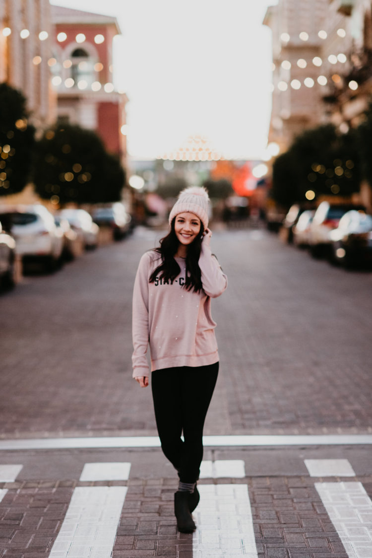 leggings with pink sweatshirt, pink beanie, and rain booties