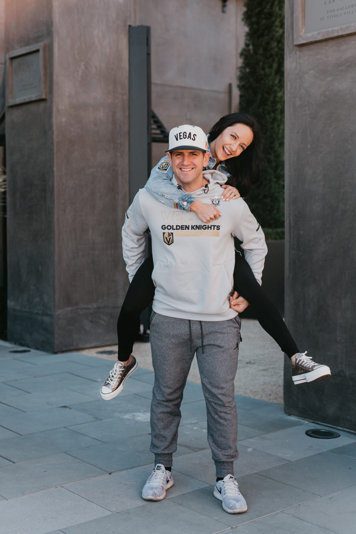 13 Best Holiday Gifts for Him featured by top Las Vegas life and style blog, Outfits & Outings: image of a couple in a street smiling