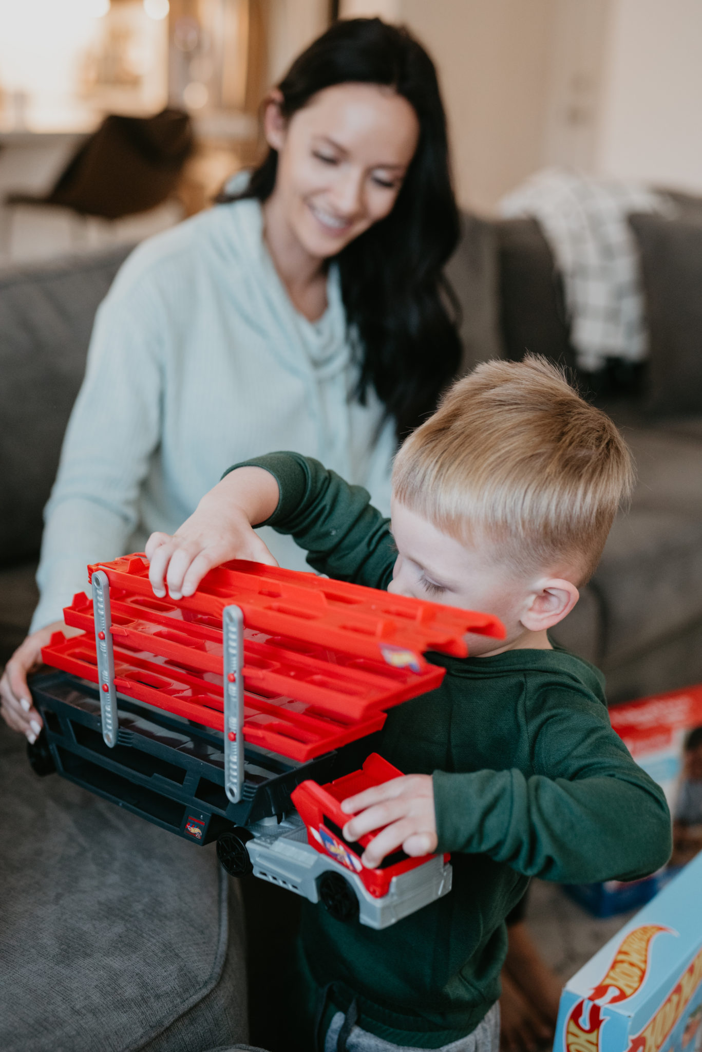 Top Kohl's Gifts for Kids featured by top Las Vegas life and style blog, Outfits & Outings: picture of a boy looking at his Kohls gifts with his mom