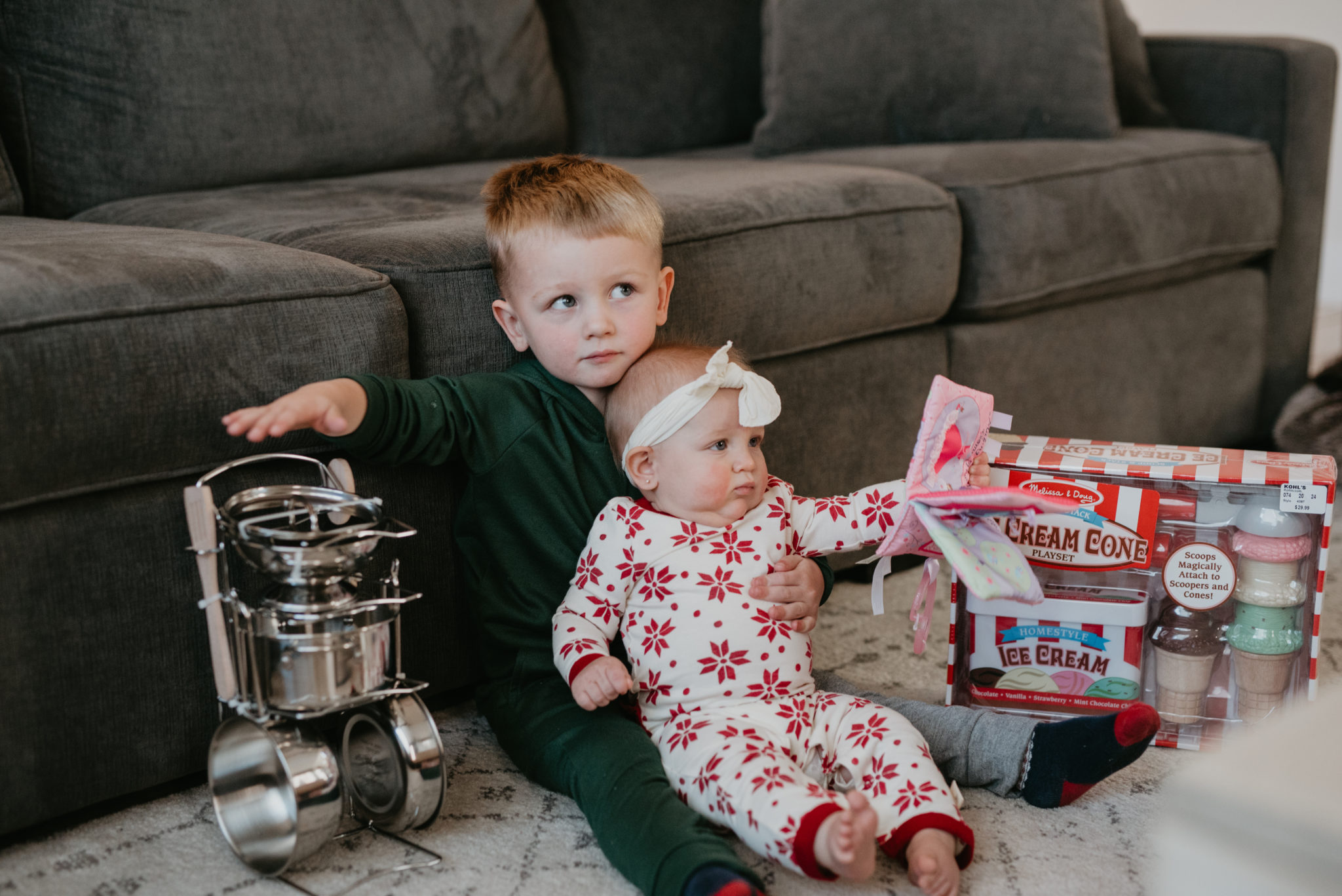 Top Kohl's Gifts for Kids featured by top Las Vegas life and style blog, Outfits & Outings: picture of cute children next to a couple of gifts from Kohl's