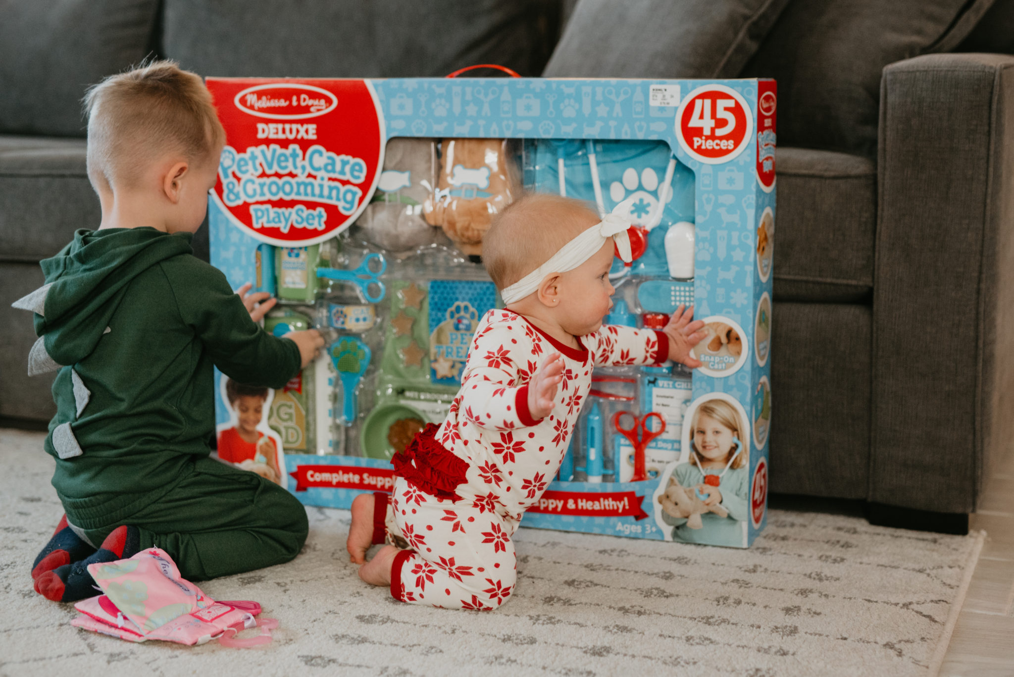 Top Kohl's Gifts for Kids featured by top Las Vegas life and style blog, Outfits & Outings: picture of cute children next to a couple of gifts from Kohl's