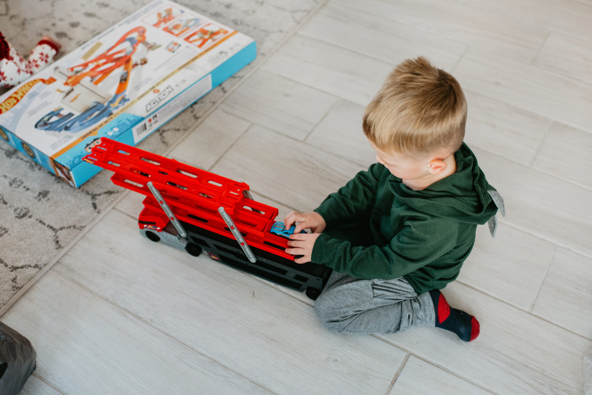 Top Kohl's Gifts for Kids featured by top Las Vegas life and style blog, Outfits & Outings: picture of a boy looking at his Kohls gifts with his mom