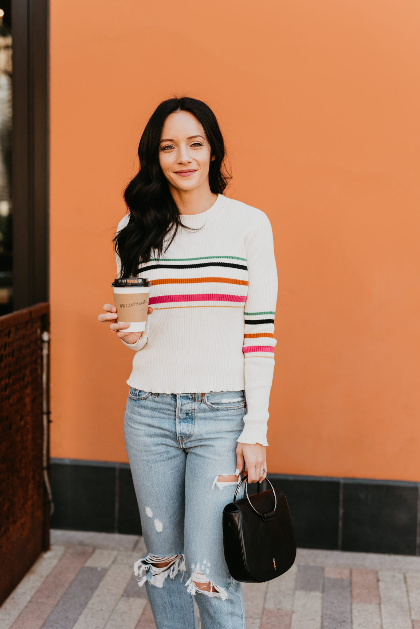 The Best Cyber Week Sales featured by top Las Vegas life and style blog, Outfits & Outings: picture of a brunette woman wearing a striped Fall sweater and distressed denim jeans