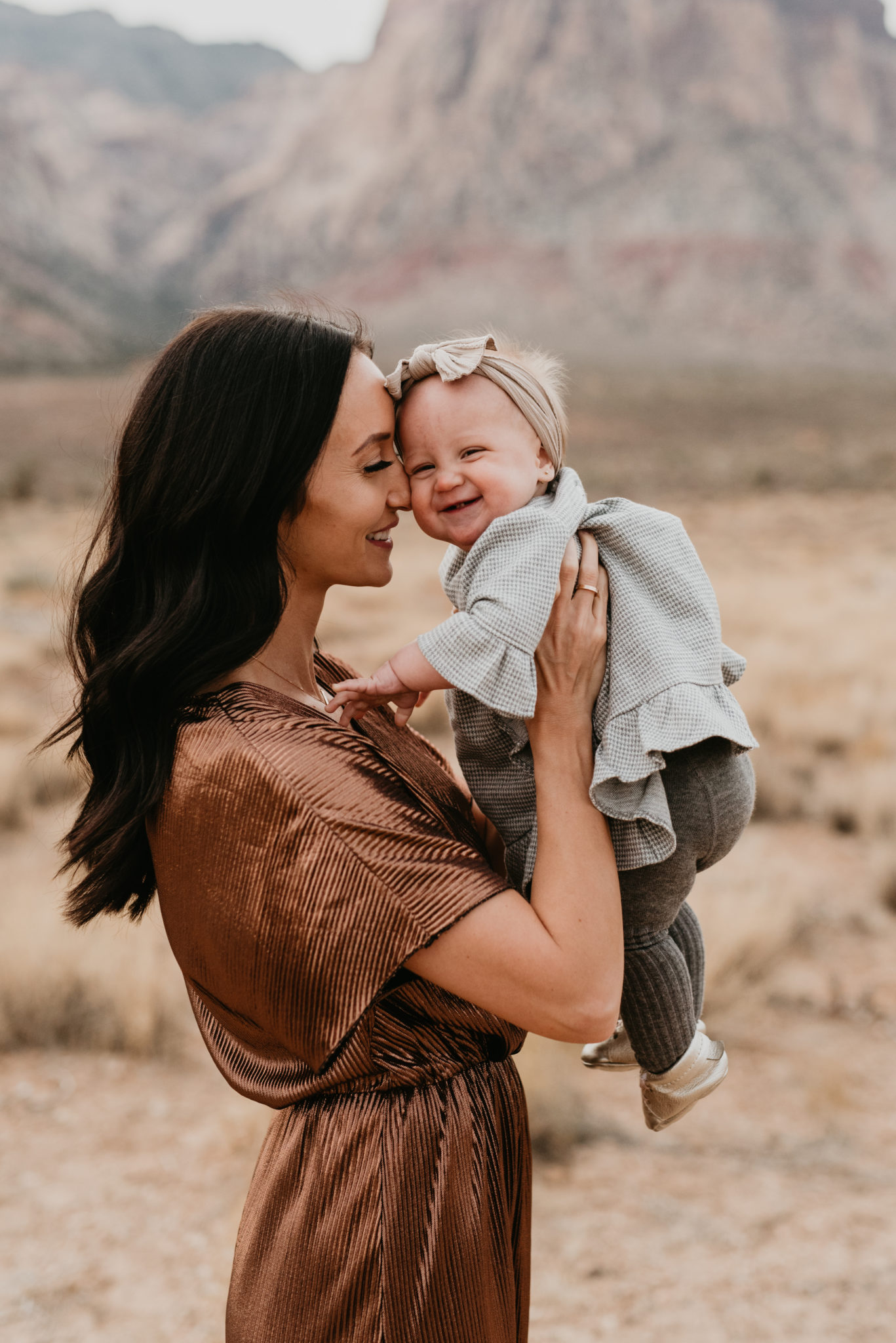 Our Holiday Family Pictures featured by top Las Vegas lifestyle blog, Outfits & Outings: image of a mom holding her baby daughter