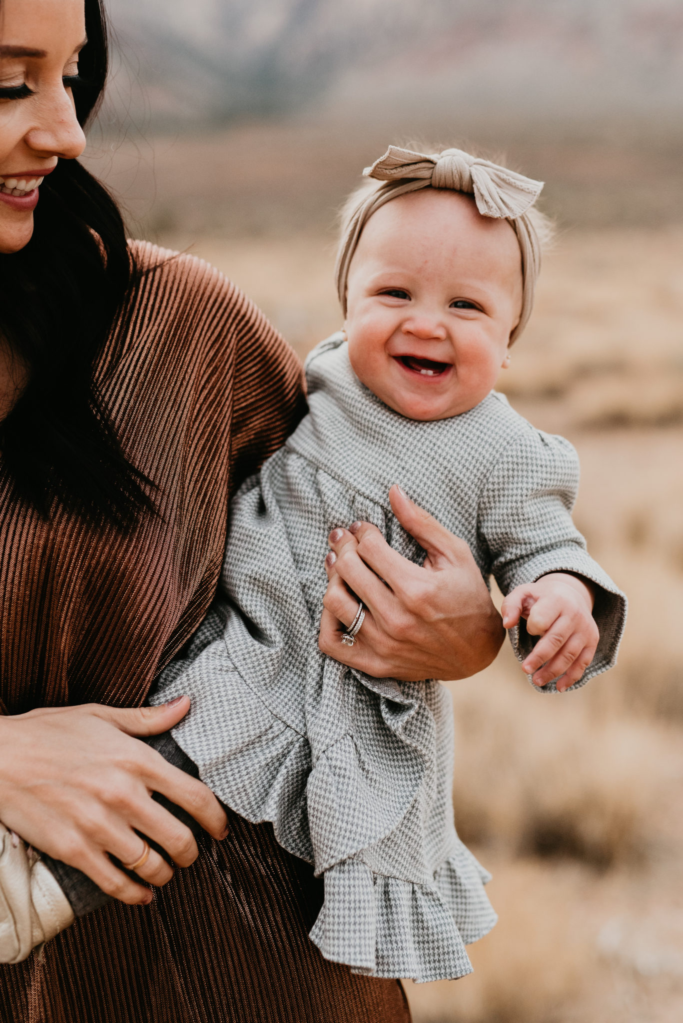 Our Holiday Family Pictures featured by top Las Vegas lifestyle blog, Outfits & Outings: image of a mom holding her baby daughter
