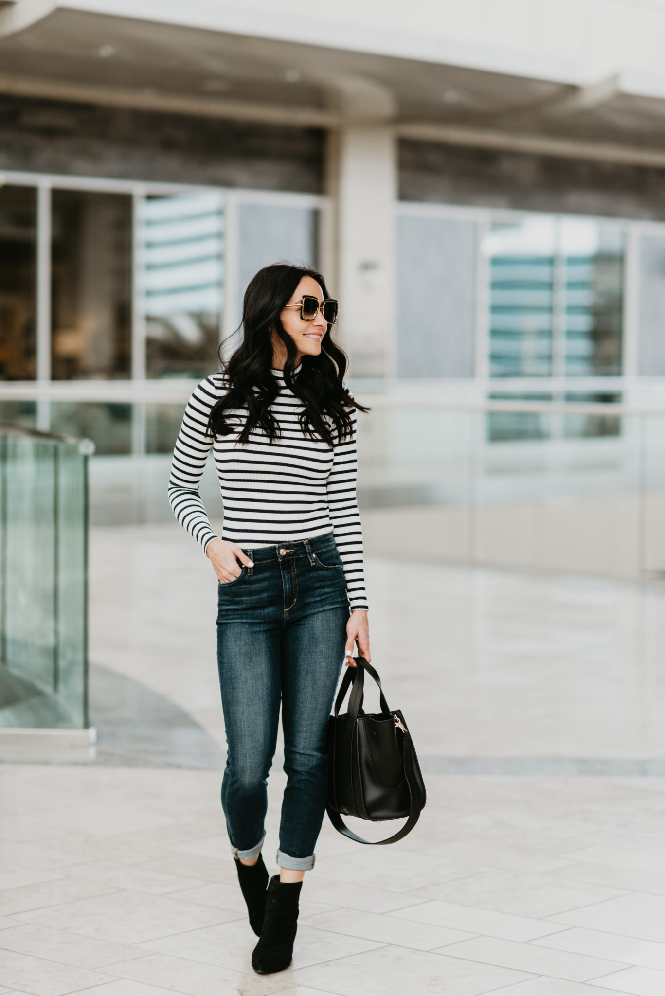 Casual Winter Outfit featured by top Las Vegas fashion blog, Outfits & Outings: image of a woman wearing a Frame Striped Turtleneck tee available at Nordstrom, a ZAC Posen tote, Joe’s Ankle Skinny jeans, Optica sunglasses and Marc Fisher booties