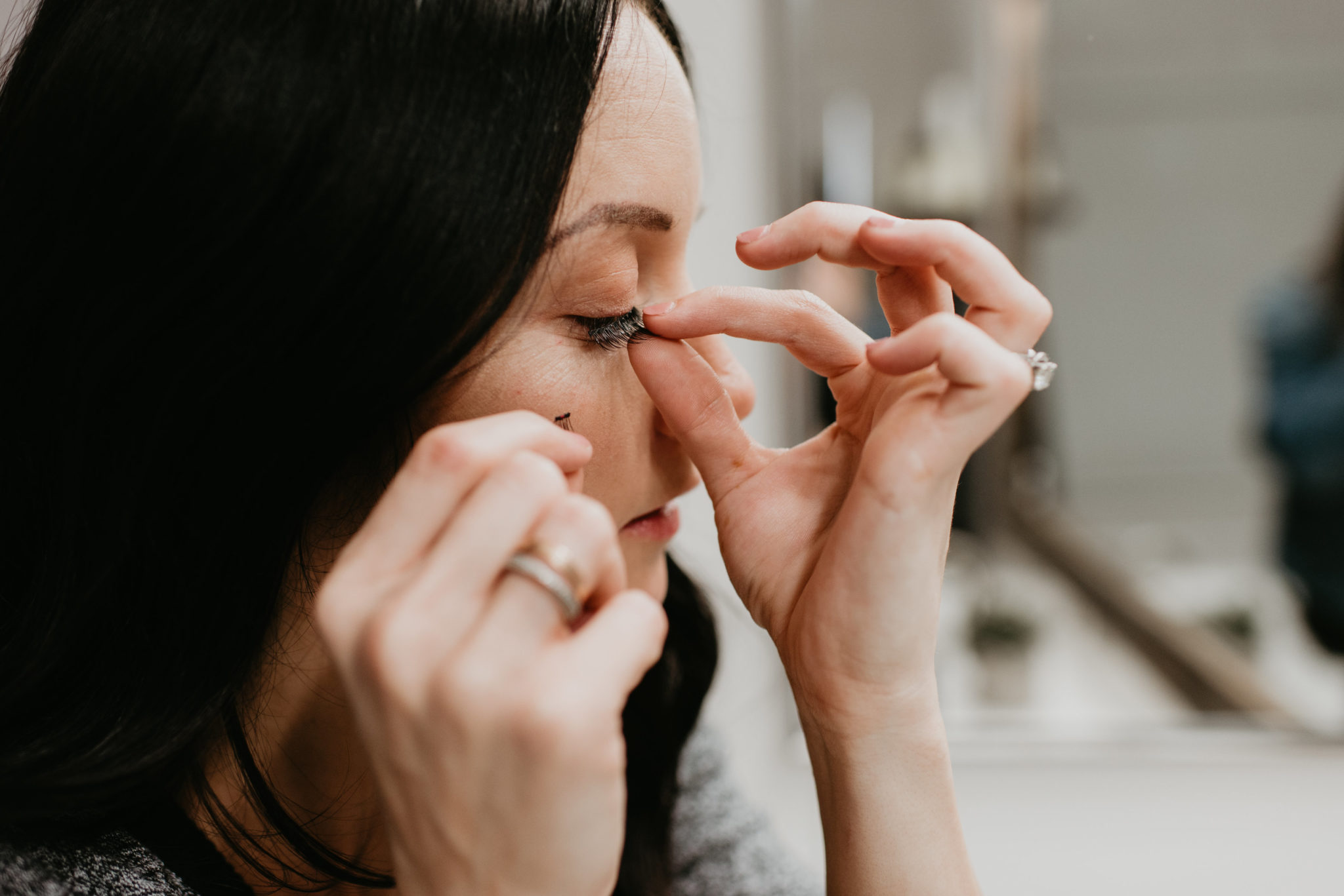 Complete magnetic lash review featured by top Las Vegas beauty blog, Outfits & Outings: image of a woman applying One Two Cosmetics magnetic lashes