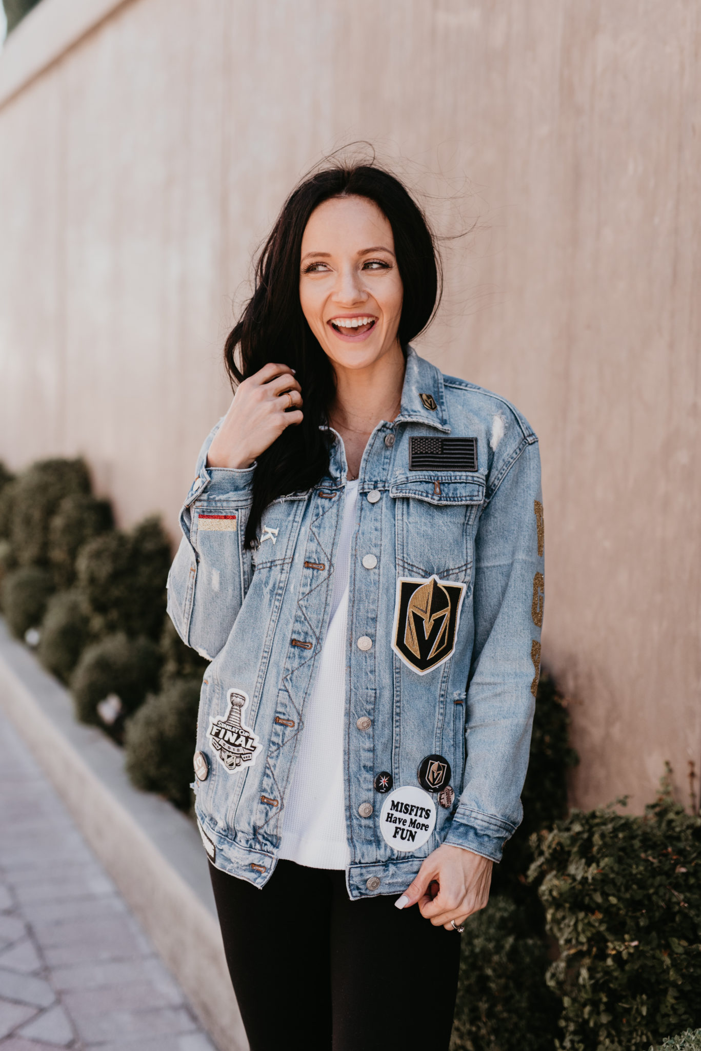 Custom Denim Jacket with Patches featured by top US fashion blog, Outfits and Outings: image of a woman wearing a custom denim jacket adorned with vinyl VGK letters.