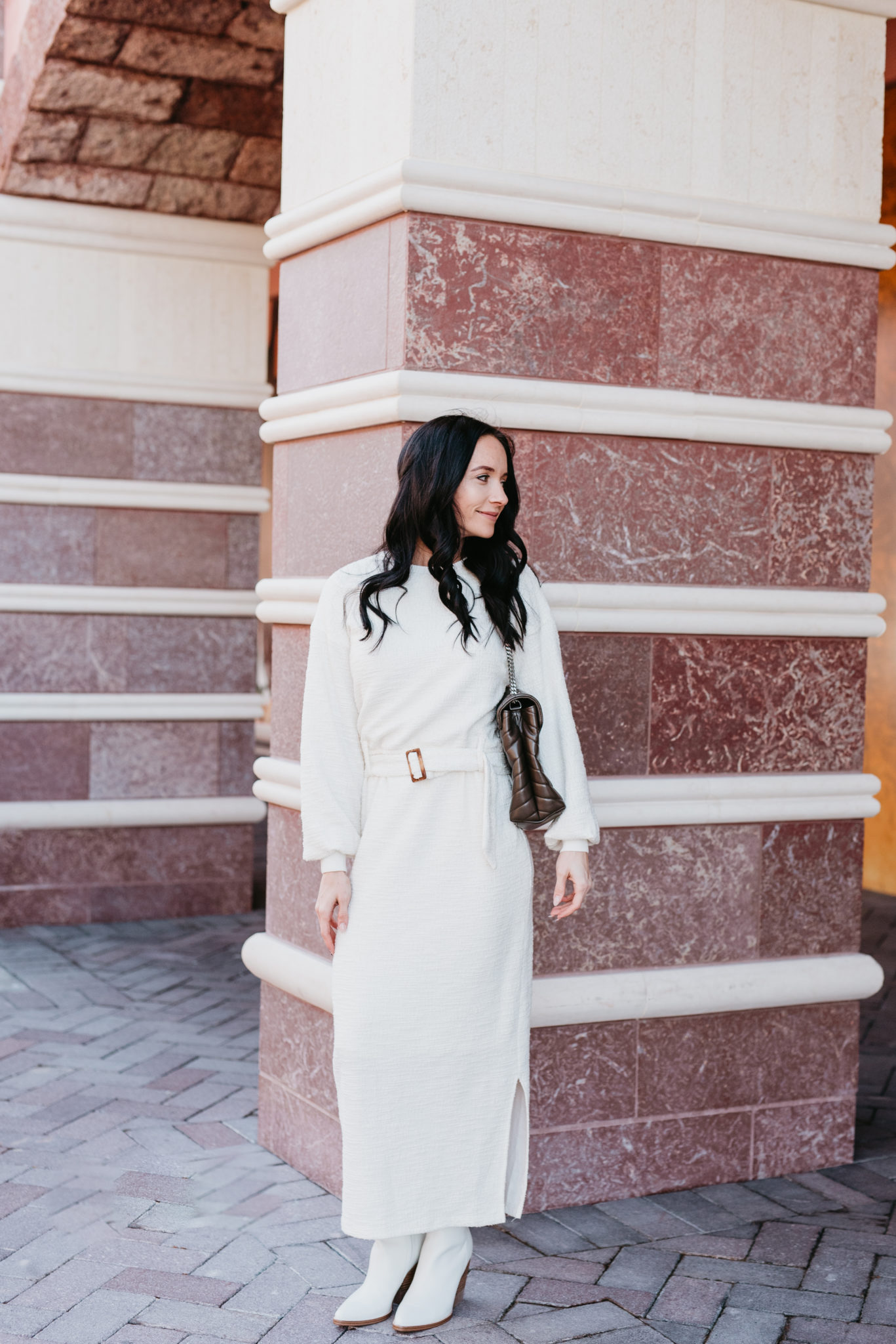 Cute Spring dress look styled by top US fashion blog, Outfits & Outings: image of a woman wearing a white Anthropologie belted dress, Yves Saint Laurent shoulder bag, and Marc Fisher white booties