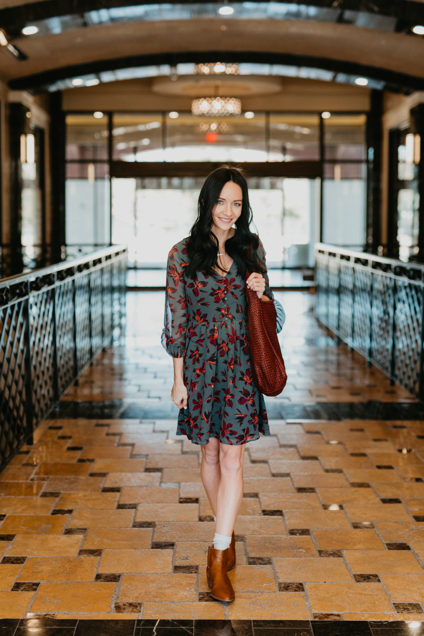 Cute Spring dress look styled by top US fashion blog, Outfits & Outings: image of a woman wearing a Madewell ruffle sleeve dress, and Madewell booties