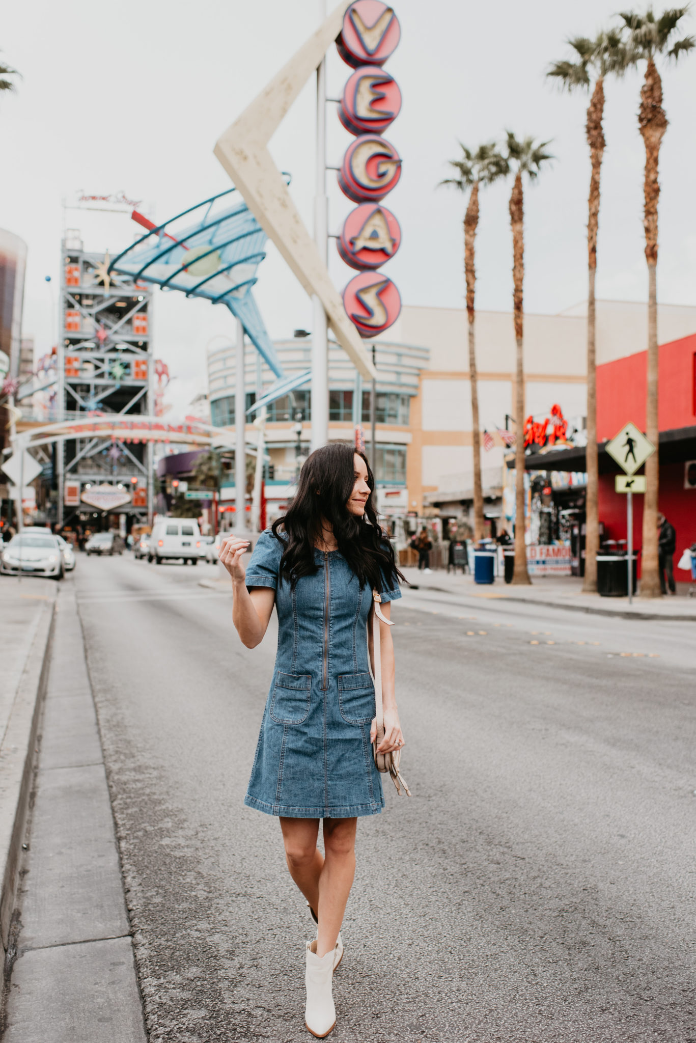 Cute Spring dress look styled by top US fashion blog, Outfits & Outings: image of a woman wearing a Madewell denim dress, Marc Fisher booties and a Chloe crossbody bag
