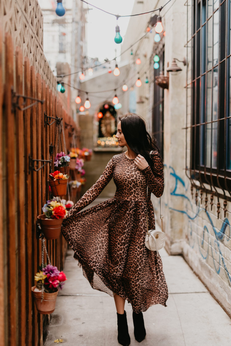Animal print maxi dress featured by top US fashion blog, Outfits & Outings: image of a woman wearing a Ganni leopard maxi dress, Marc Fisher booties and a Gucci Marmont camera bag
