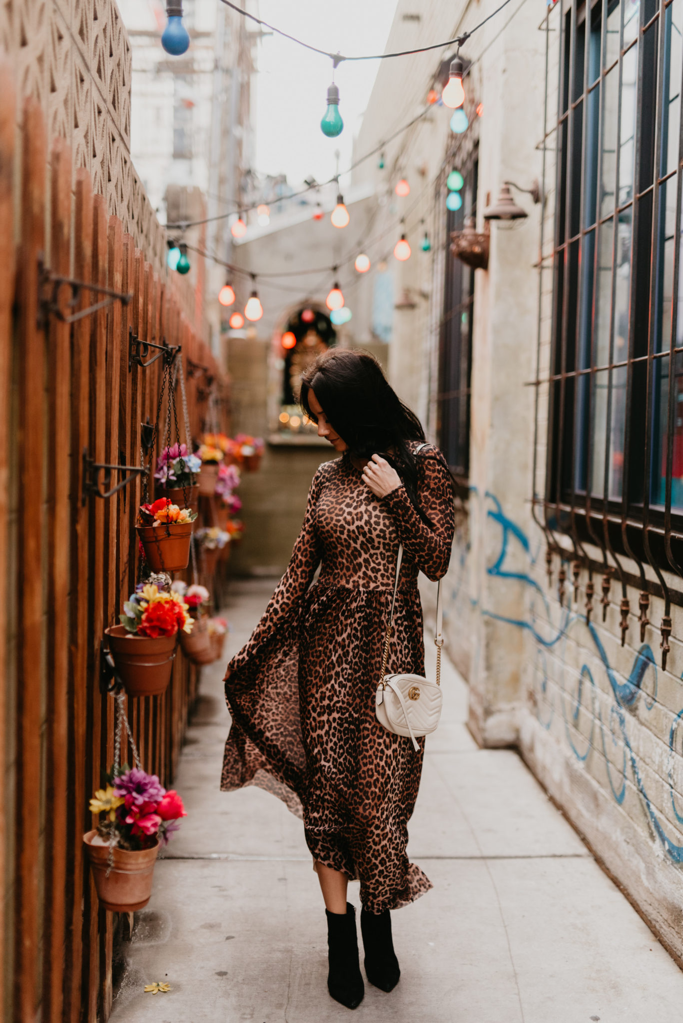 Animal print maxi dress featured by top US fashion blog, Outfits & Outings: image of a woman wearing a Ganni leopard maxi dress, Marc Fisher booties and a Gucci Marmont camera bag