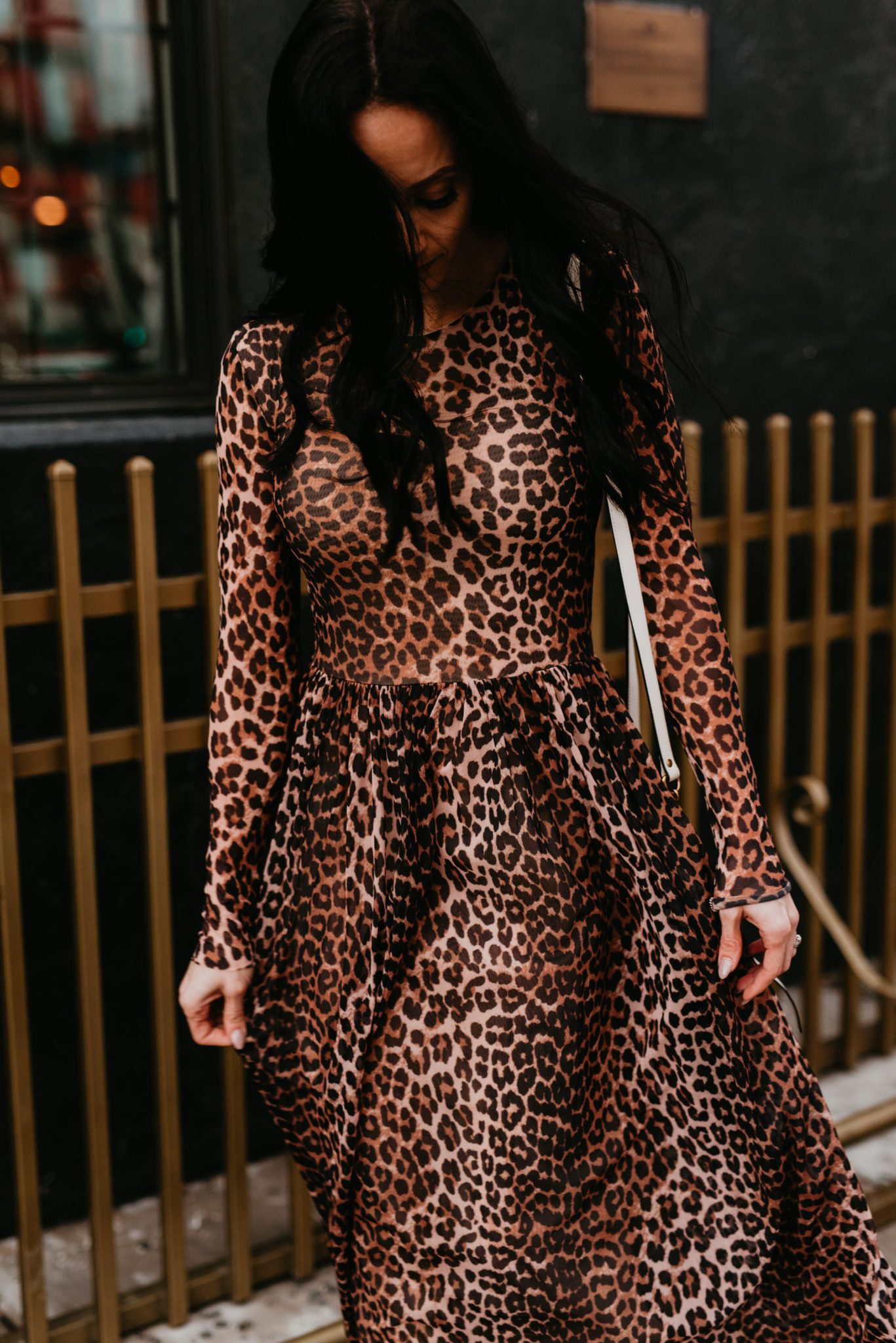Cute Spring dress look styled by top US fashion blog, Outfits & Outings: image of a woman wearing a Ganni leopard maxi dress and a Gucci Mormont camera bag
