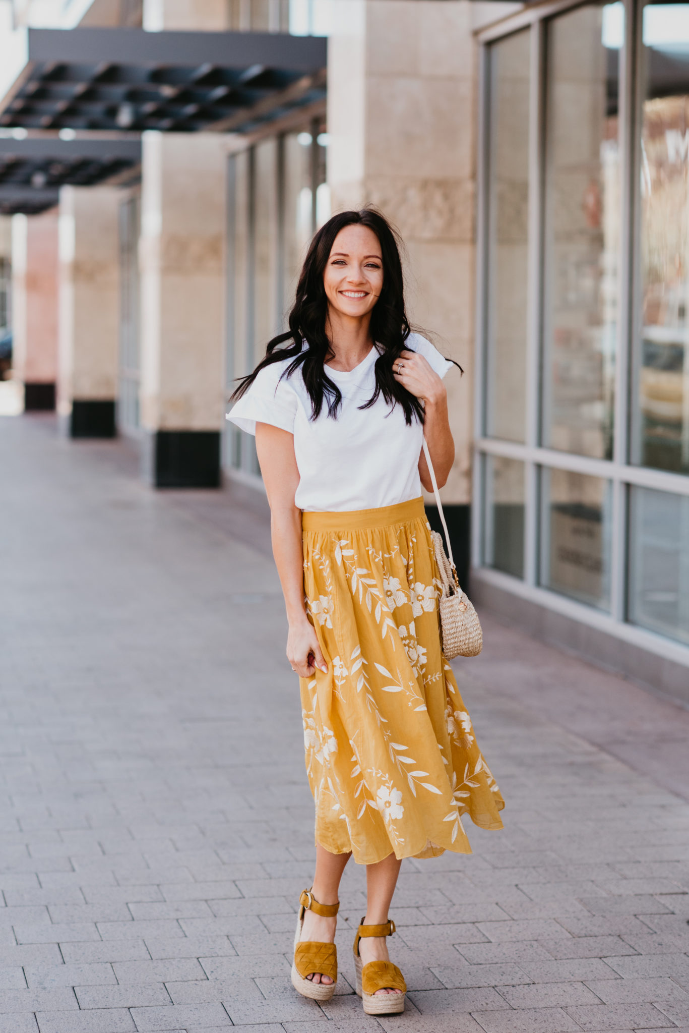 Spring essentials featured by top US fashion blog, Outfits & Outings: image of a woman wearing an Anthropologie floral skirt
