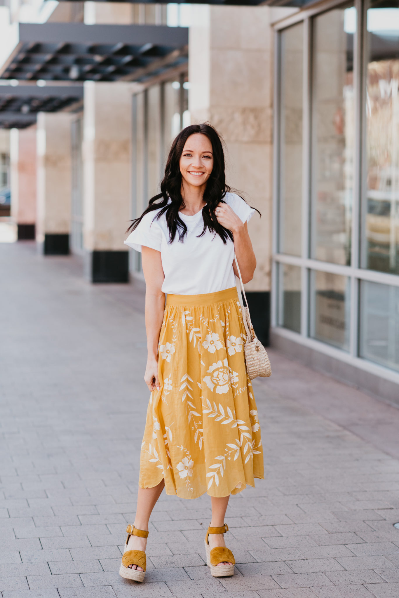 Cute Yellow Skirts for Spring featured by top US fashion blog, Outfits & Outings: image of a woman wearing a white top, yellow embroidered skirt and Marc Fisher espadrilles sandals