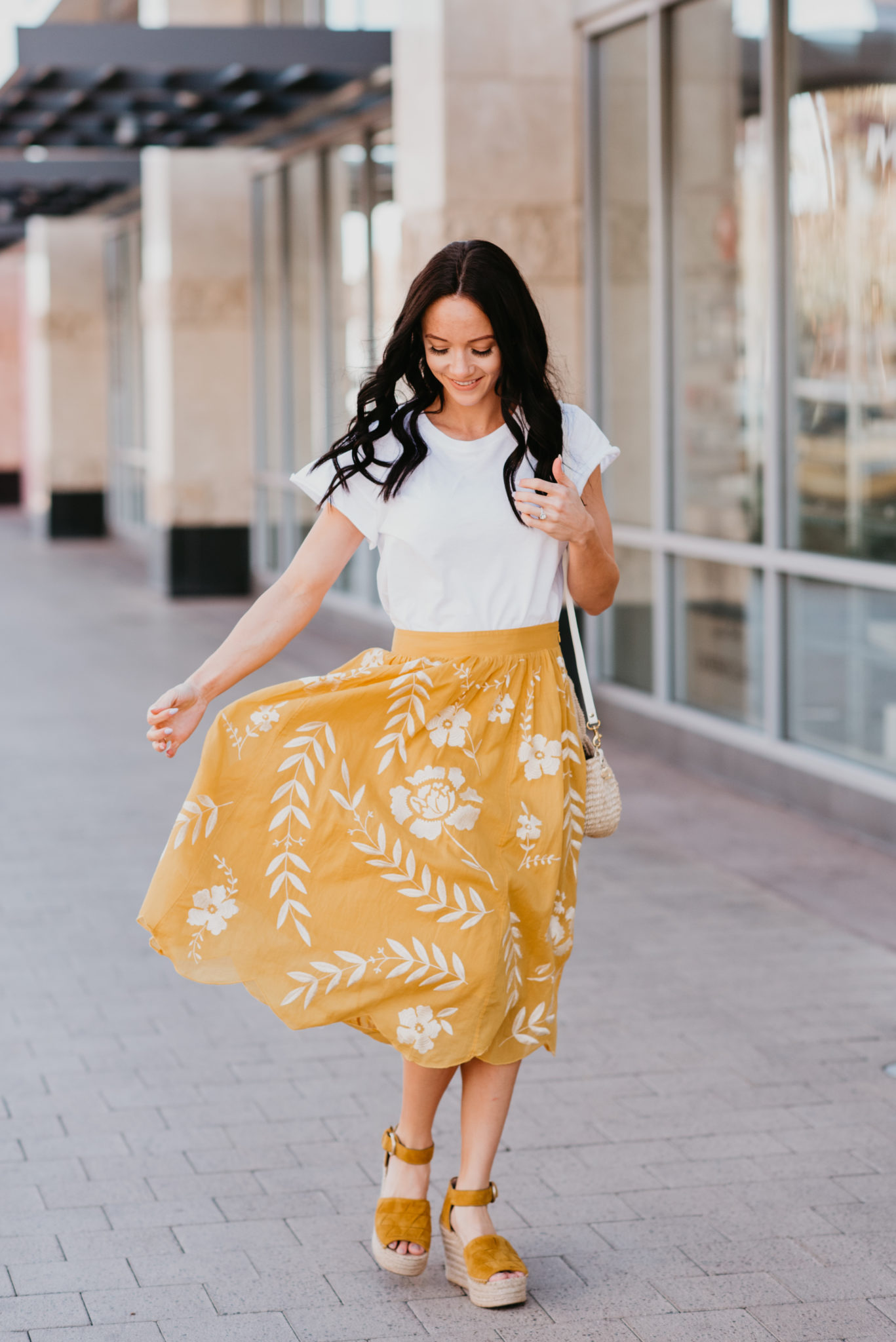 Cute Yellow Skirts for Spring featured by top US fashion blog, Outfits & Outings: image of a woman wearing a white top, yellow embroidered skirt and Marc Fisher espadrilles sandals