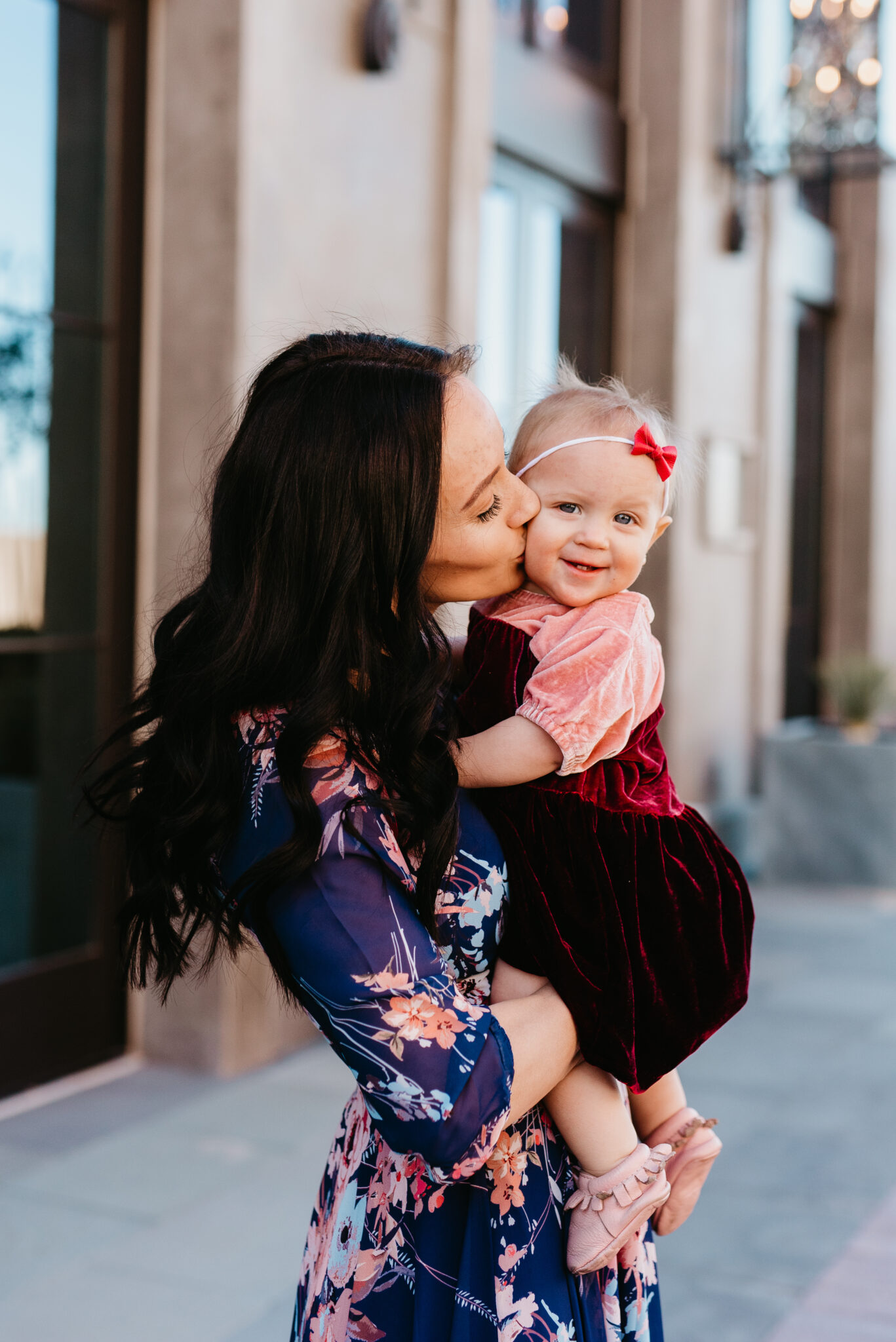 Cute Easter Dresses for Spring featured by top US fashion blog, Outfits & Outings: image of a woman wearing a maxi floral dress with her baby wearing a pink color block dress