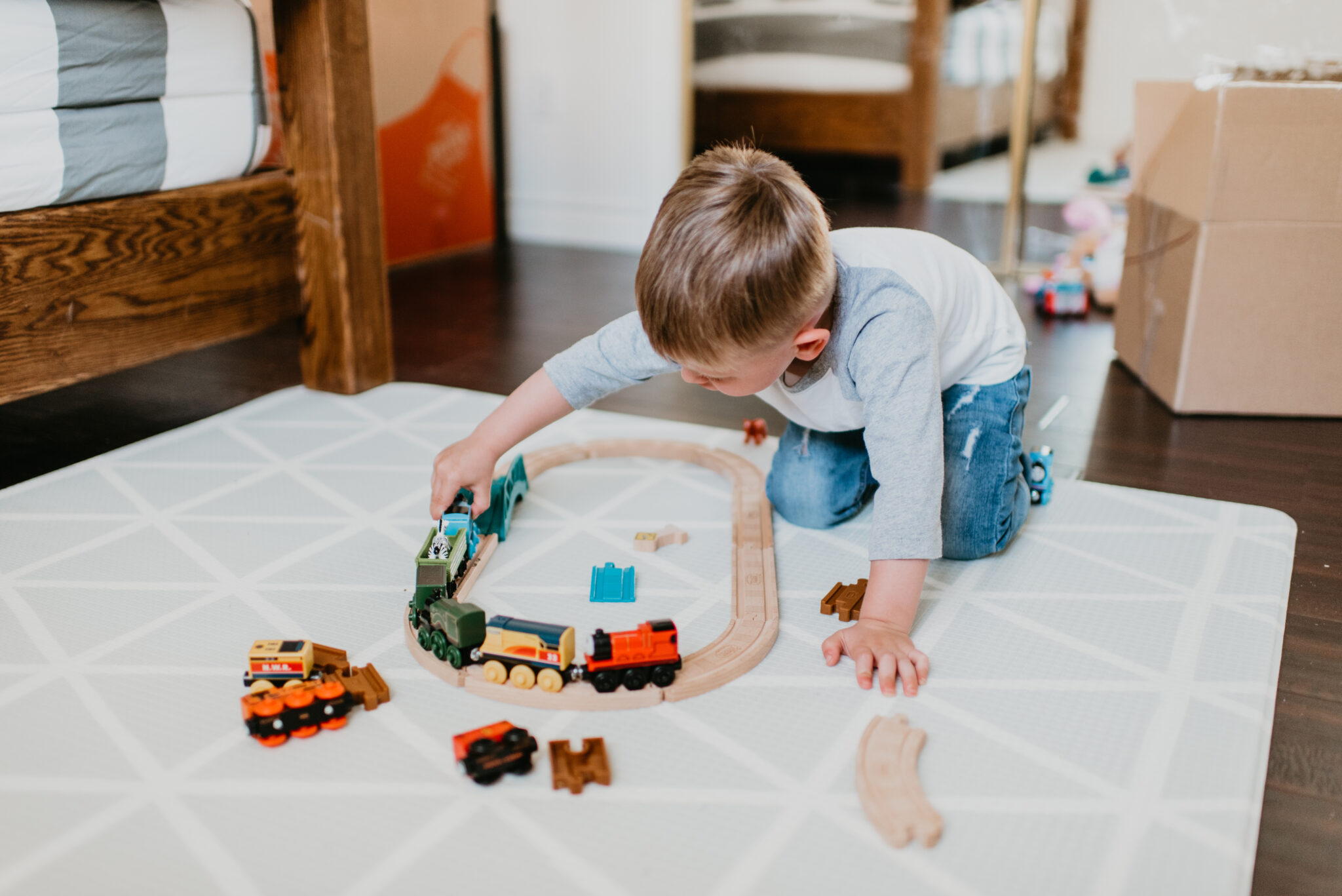 Fisher Price educational toys for toddlers, featured by top US lifestyle blog, Outfits and Outings: image of a toddler playing with a Thomas the Train wooden train playset