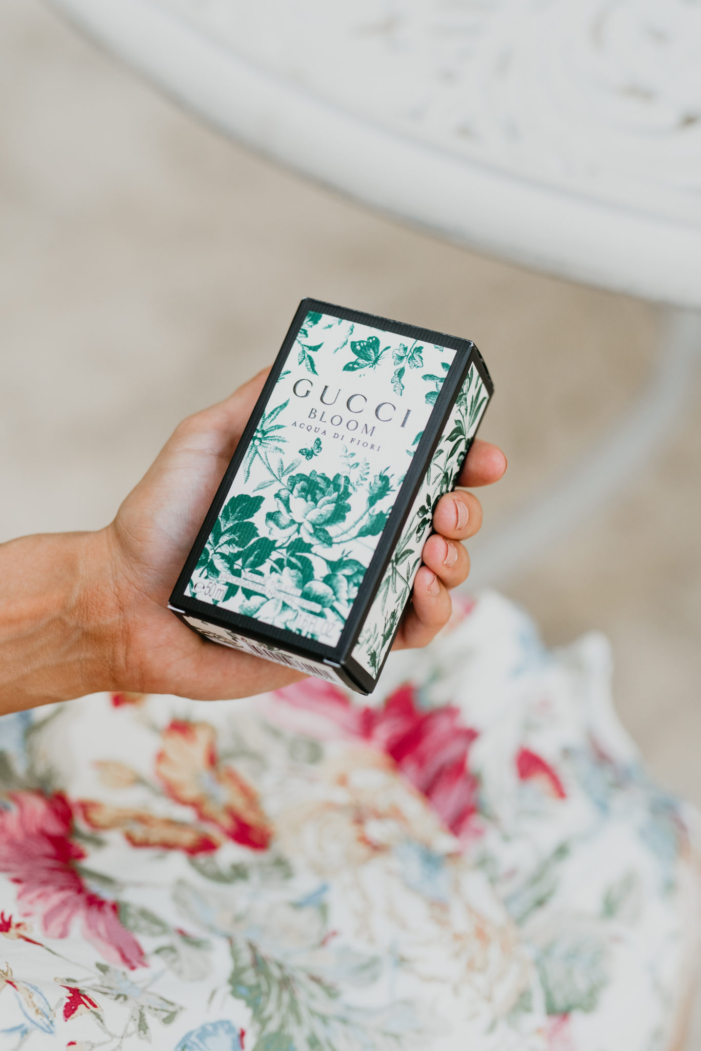 Unique Mothers Day Gift Idea featured by top US life and style blog, Outfits & Outings: image of a woman holding the GUCCI in Bloom Acqua di Fiore fragrance