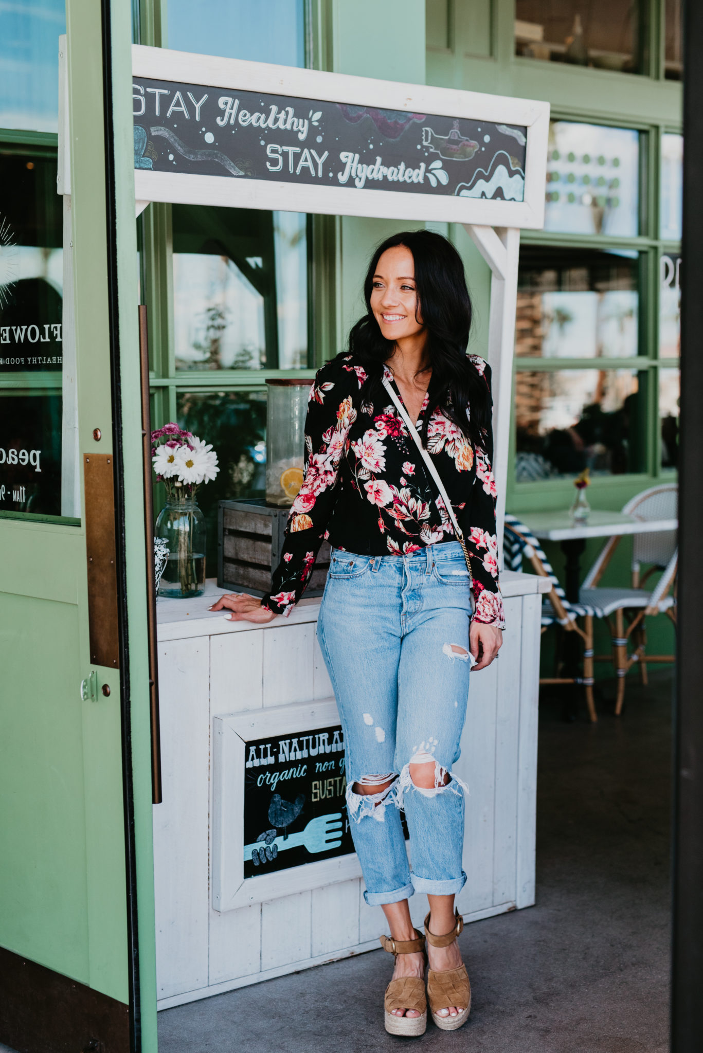 Cute bodysuits featured by top US fashion blog, Outfits & Outings: image of a woman wearing an AFRM floral bodysuit, Levi’s high waist crop jeans, Marc Fisher espadrille platform wedges, and a Gucci small Marmont 2.0