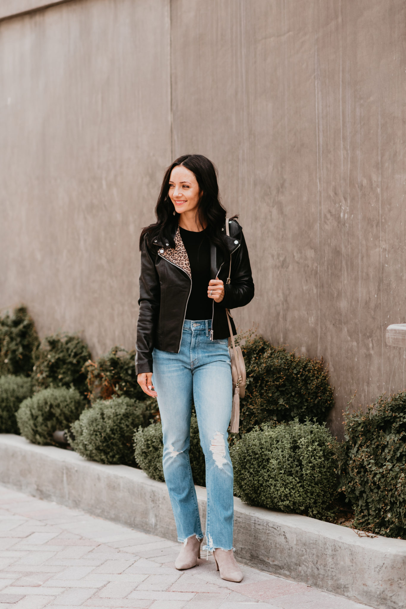 Cute Fall Jackets styled by top US fashion blog, Outfits & Outings: image of a woman wearing a Bernardo leopard leather moto jacket.