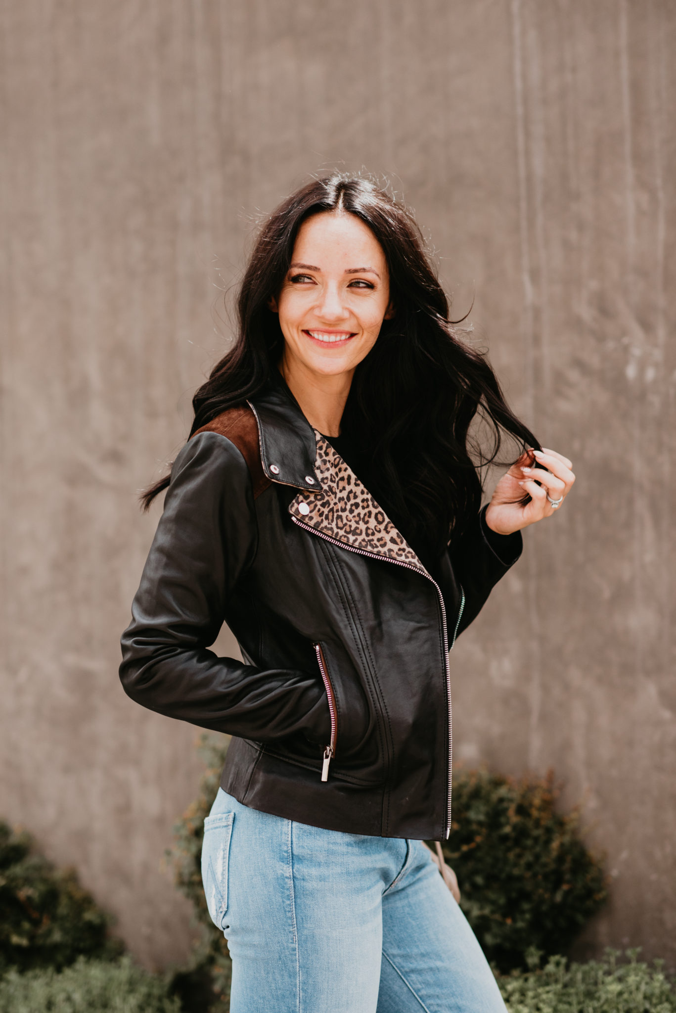 Cute Fall Jackets styled by top US fashion blog, Outfits & Outings: image of a woman wearing a Bernardo leopard leather moto jacket.