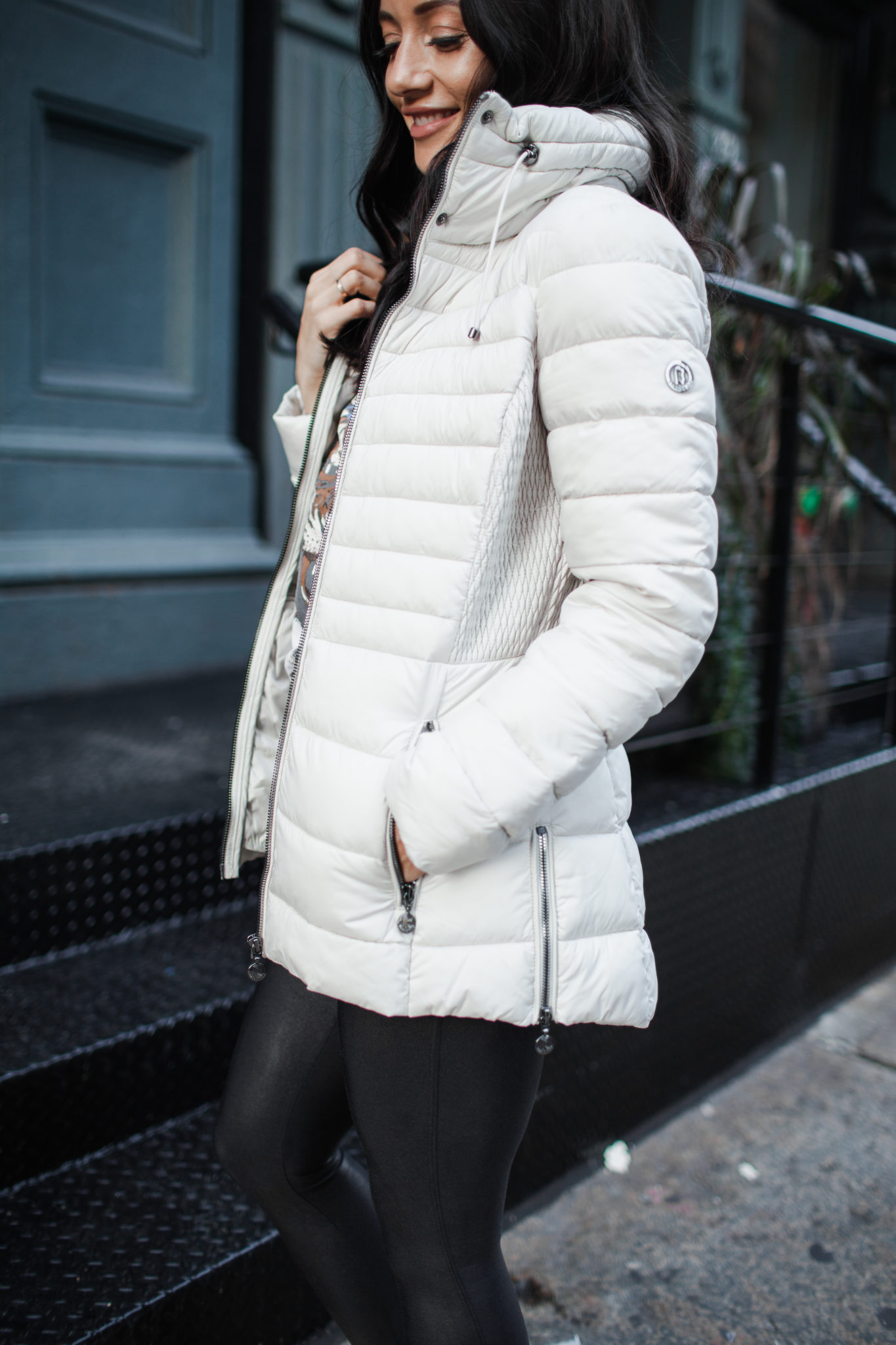 Cute Fall Jackets styled by top US fashion blog, Outfits & Outings: image of a woman wearing a Bernardo puffer jacket, faux leather leggings and white faux fur hiking boots.