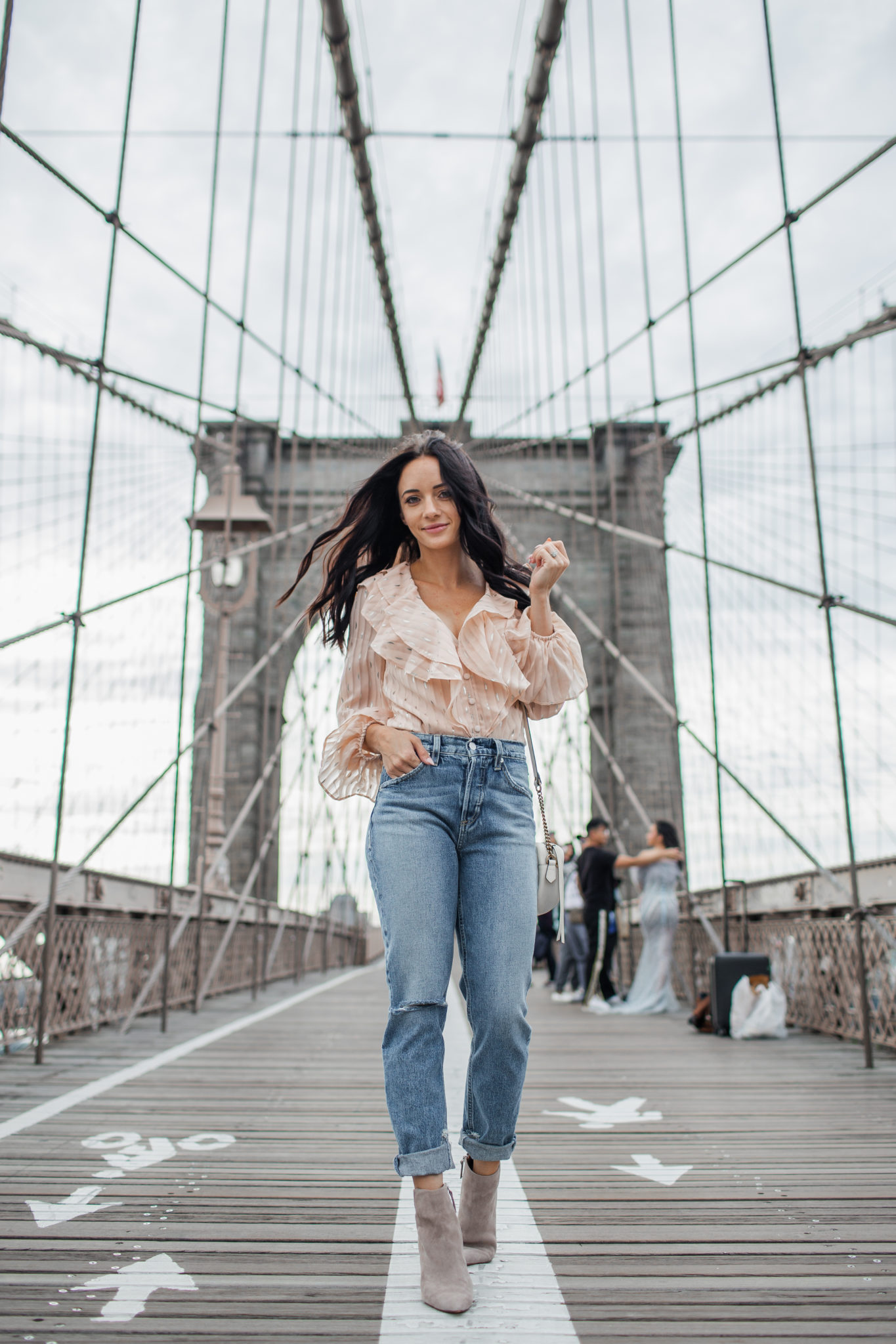 How to style a striped bodysuit for Fall, tips featured by top US fashion blog, Outfits & Outings: image of a woman wearing a REVOLVE striped bodysuit, SOCIALITE high waist slim jeans, and Vince Camuto suede booties.