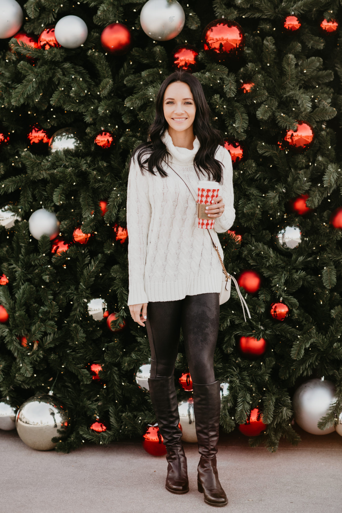 Festive Christmas Outfit Ideas featured by top US fashion blog, Outfits & Outings: image of a woman wearing Spanx Faux Leather Leggings & a Sweater