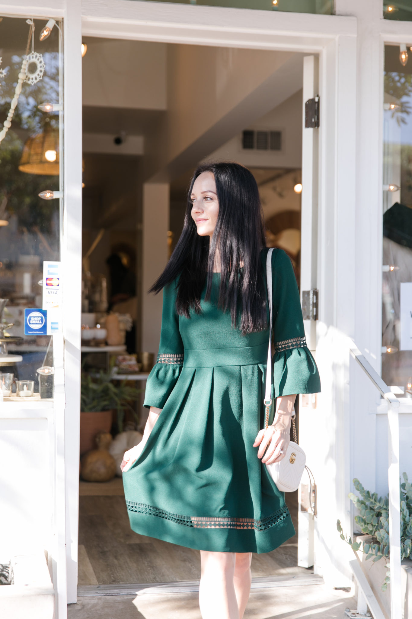 Festive Christmas Outfit Ideas featured by top US fashion blog, Outfits & Outings: image of a woman wearing a Green dress