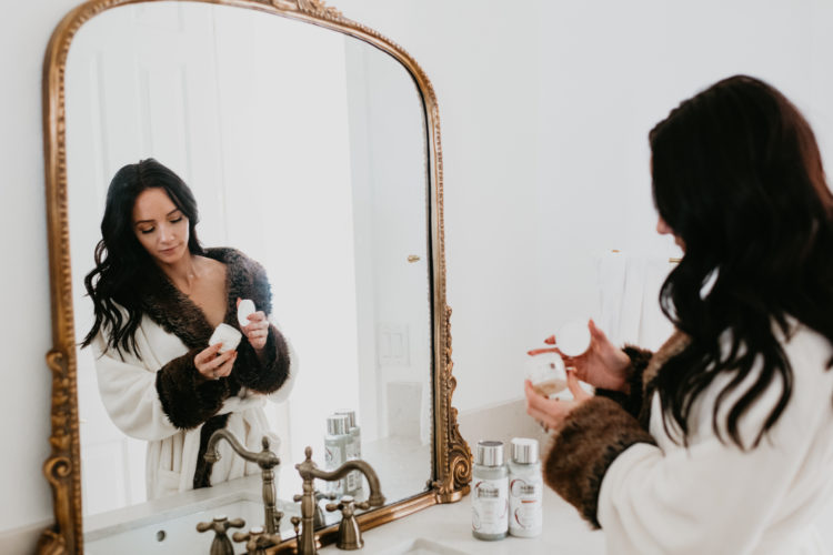 Re-fresh scalp care review: the best products for dandruff. A review featured by top Las Vegas beauty blog, Outfits and Outings | Re-Fresh Scalp Care by popular Las Vegas hair and beauty blog, Outfits and Outings: image of a woman opening a Re-Fresh Scalp Care product.