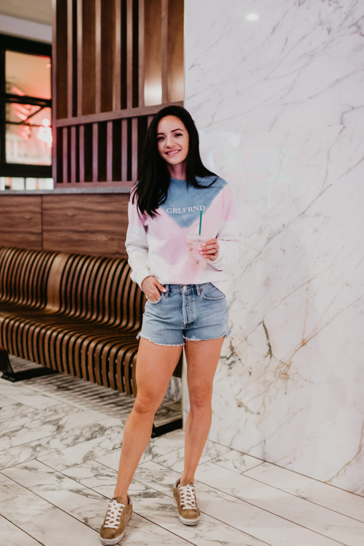 What to wear with denim shorts in the Spring, denim shorts outfit ideas featured by top Las Vegas fashion blog, Outfits & Outings: image of a woman wearing Agolde Parker denim shorts 
