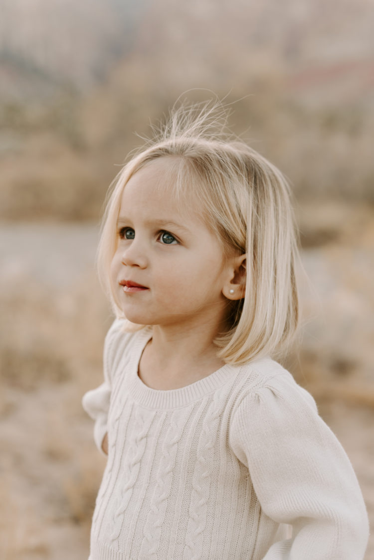 Family Picture Ideas by popular Las Vegas fashion blog, Outfits and Outings: image of a little girl wearing a cream sweater. 