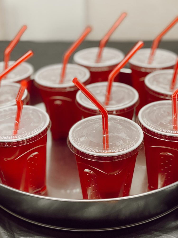 Birthday Party Ideas by popular Las Vegas lifestyle blog, Outfits and Outings: image of red plastic cups with lids and straws and filled with soda. 