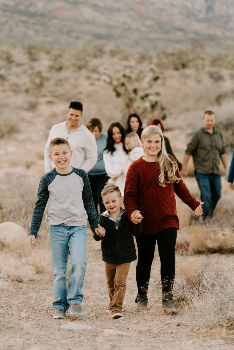 Family Picture Ideas by popular Las Vegas fashion blog, Outfits and Outings: image of family walking together in the desert. 
