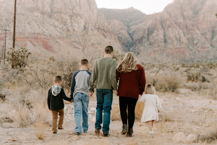 Family Picture Ideas by popular Las Vegas fashion blog, Outfits and Outings: image of a family walking together in the desert. 